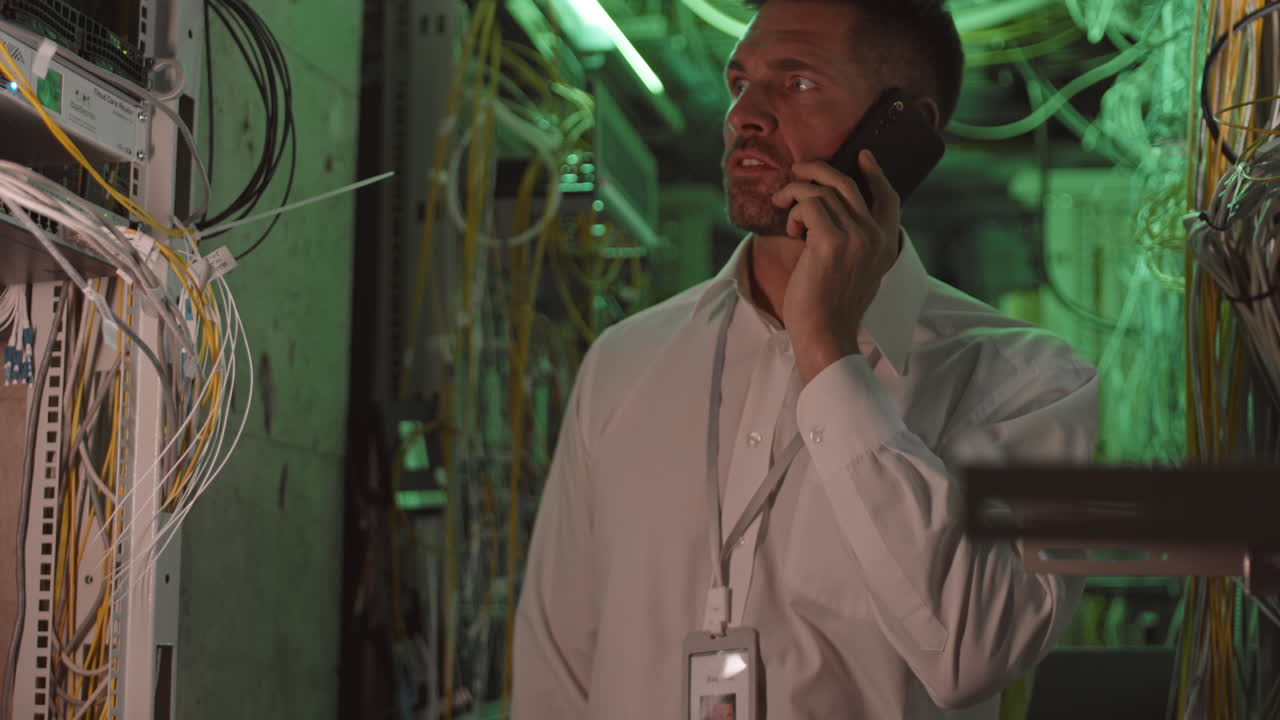 IT Professional Talking on Phone in Server Room