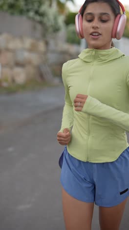 woman running outdoors with headphones