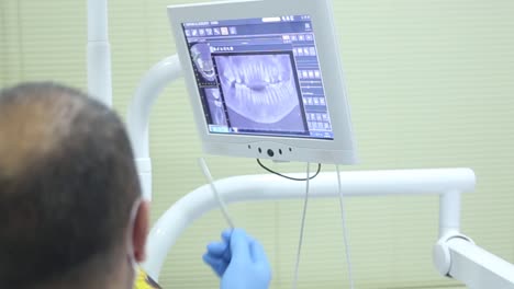 the dentist reviews the condition of his patient