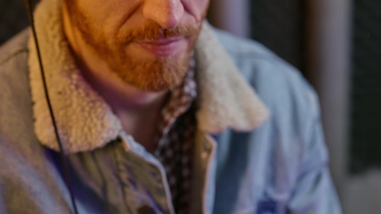 Close up on radio or podcast host adjusting microphone and speaks in sound studio. Young man's hands set mic close to his mouth. Recoding in professional audio room a live streaming podcast show
