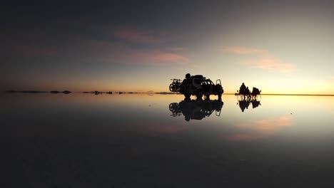 truck parked in salar de uyuni, sunset with friends