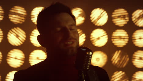 man vocalist performing song in nightclub close up. guy musician singing mic.