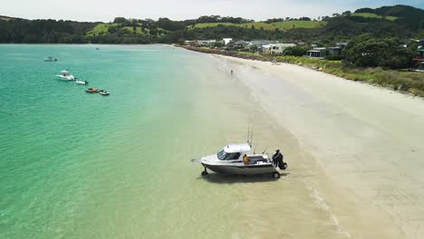 amphibious fishing boat driving from the beach into the water at high tide