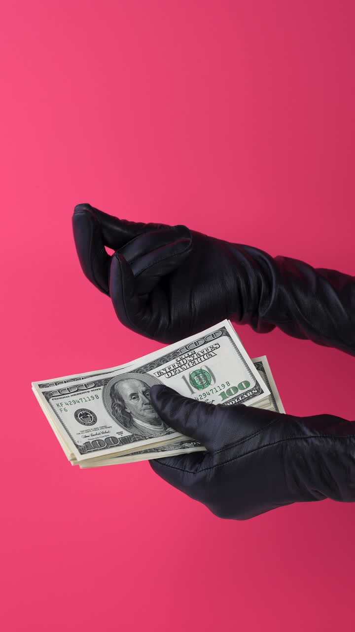 Hands in Black Gloves Holding Stack of Hundred Dollar Bills
