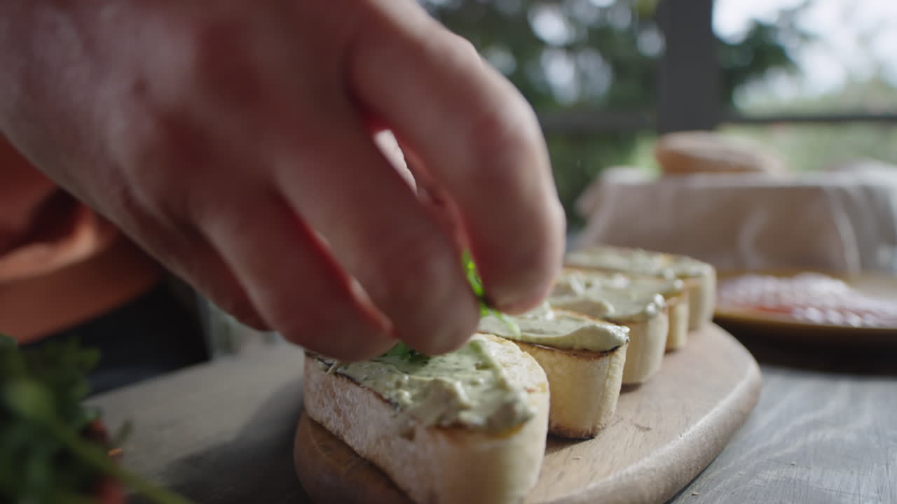 Putting Fresh Arugula on Top of Bruschettas