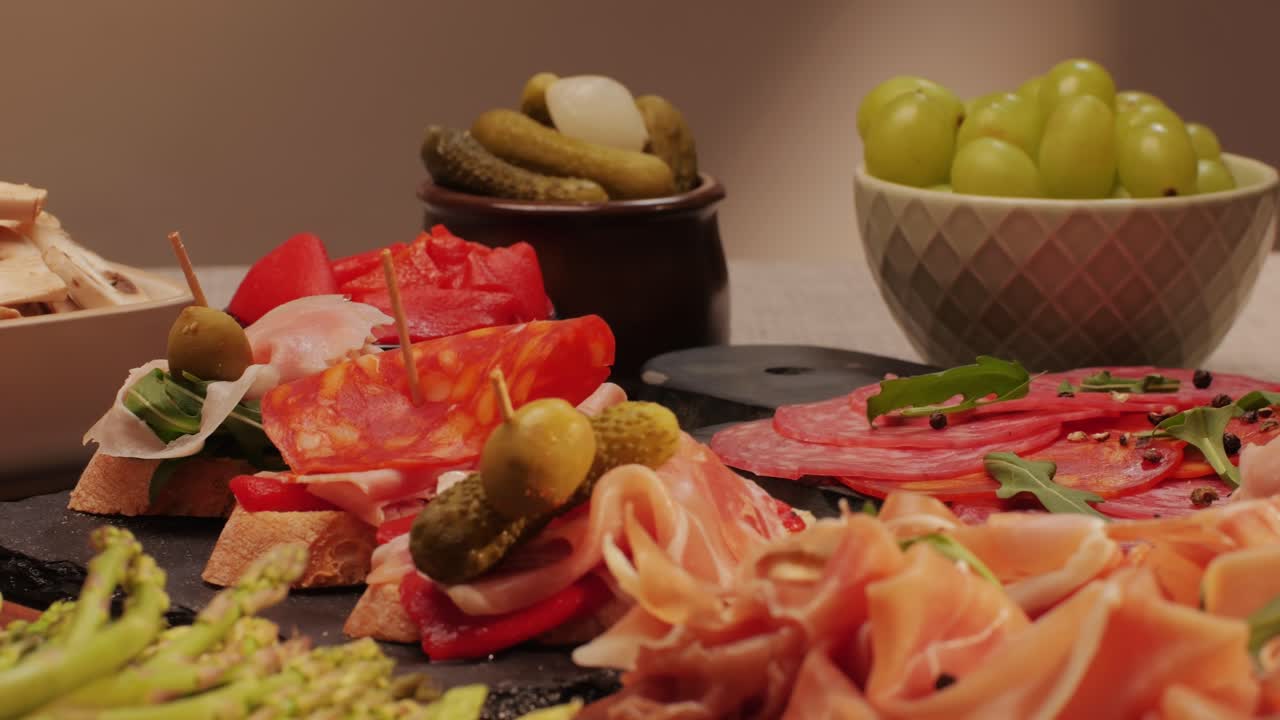 Italian or Spanish restaurant with traditional tapas food, Spanish cuisine, delicious tapas and cheese plate, bruschetta with cheese, olives dry tomatoes and tasty sandwich bar appetizer, buffet