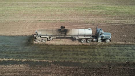 a tanker spreads liquid manure on a wisconsin farm field recently harvested of corn silage