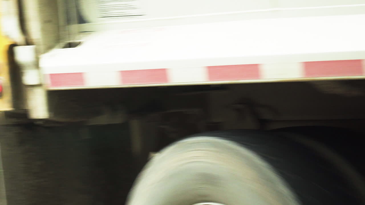 View of a garbage truck passing by after keeping a black trash box close to the camping site in Glacier NP Campground and Creek in United States
