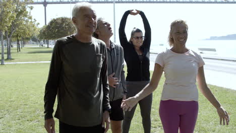 older men and women warming and stretching muscles