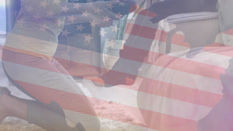 animation of flag of usa over caucasian mother helping son to put on shoes