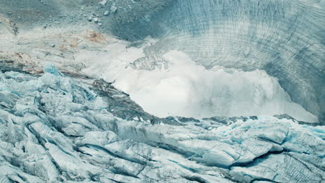 icebergs falling in the water while a glacier is melting due to climate change