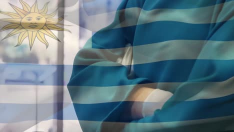 Animation-of-flag-of-uruguay-waving-over-surgeons-in-face-masks