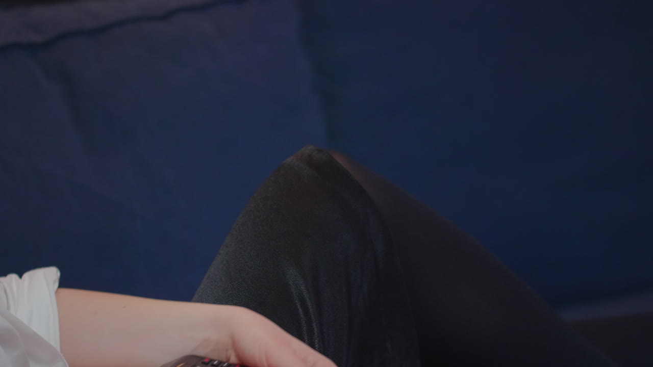 Close up of caucasian hand using remote controller for TV searching channels