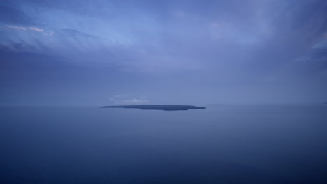 wide drone shot flying over lake michigan towards the uninhabited little summer island