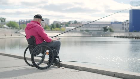 person with a physical disability who uses wheelchair fishing from fishing pier