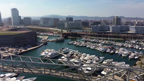 Aerial-shot-of-the-Forum-port-with-the-views-of-the-spectacular-city-of-Barcelona-in-Spain-in-the-background-on-a-sunny-day