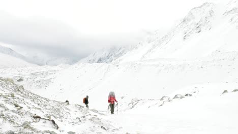 backpackers on larke pass in nepal, 5100m altitude. manaslu circuit trek area.