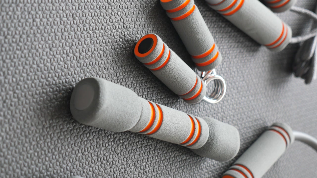 Close-up of Grey and Orange Exercise Equipment on Gym Mat