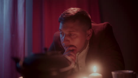 man by the window at night