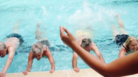 seniors swimming in the pool with inflatable tubes