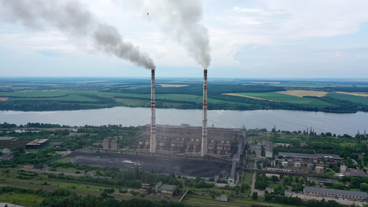 Aerial view of big factory territory with huge tubes. Industrial architecture factory warehouses.