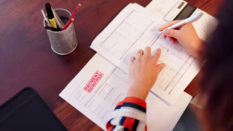 person reviewing financial documents and bills