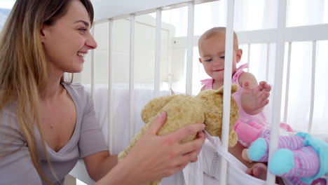 Mother-watching-her-daughter-playing-with-dolls