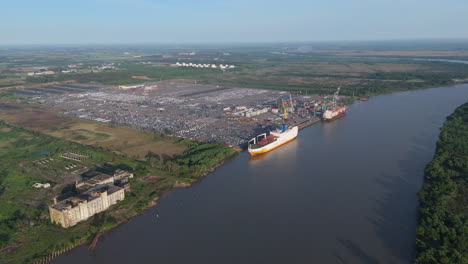 aerial view of a busy port with cargo ships and cars