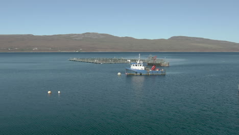 An-aerial-view-of-an-aquaculture-installation-on-Loch-Eriboll-in-the-Scottish-Highlands-on-a-sunny-day