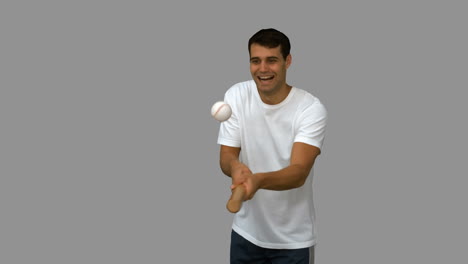 Man-dribbling-with-a-baseball-on-grey-screen