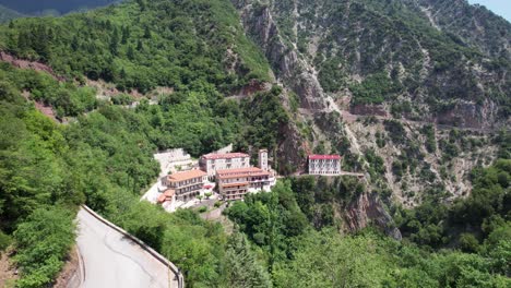 aerial view of proussos monastery in the mountains of evrytania, greece – historic cliffside monastery surrounded by forest and natural landscape