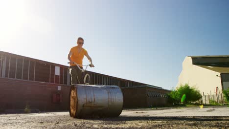 bmx rider doing trick in an empty yard