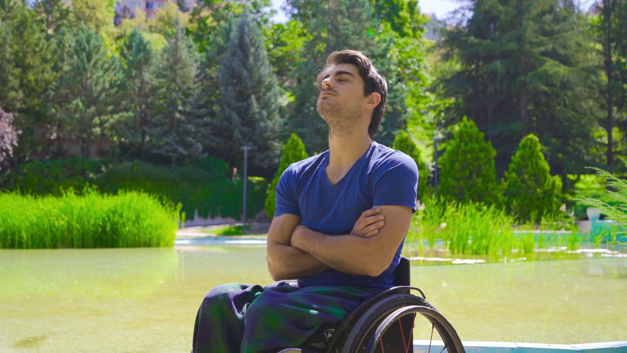 Young man in wheelchair outdoors.