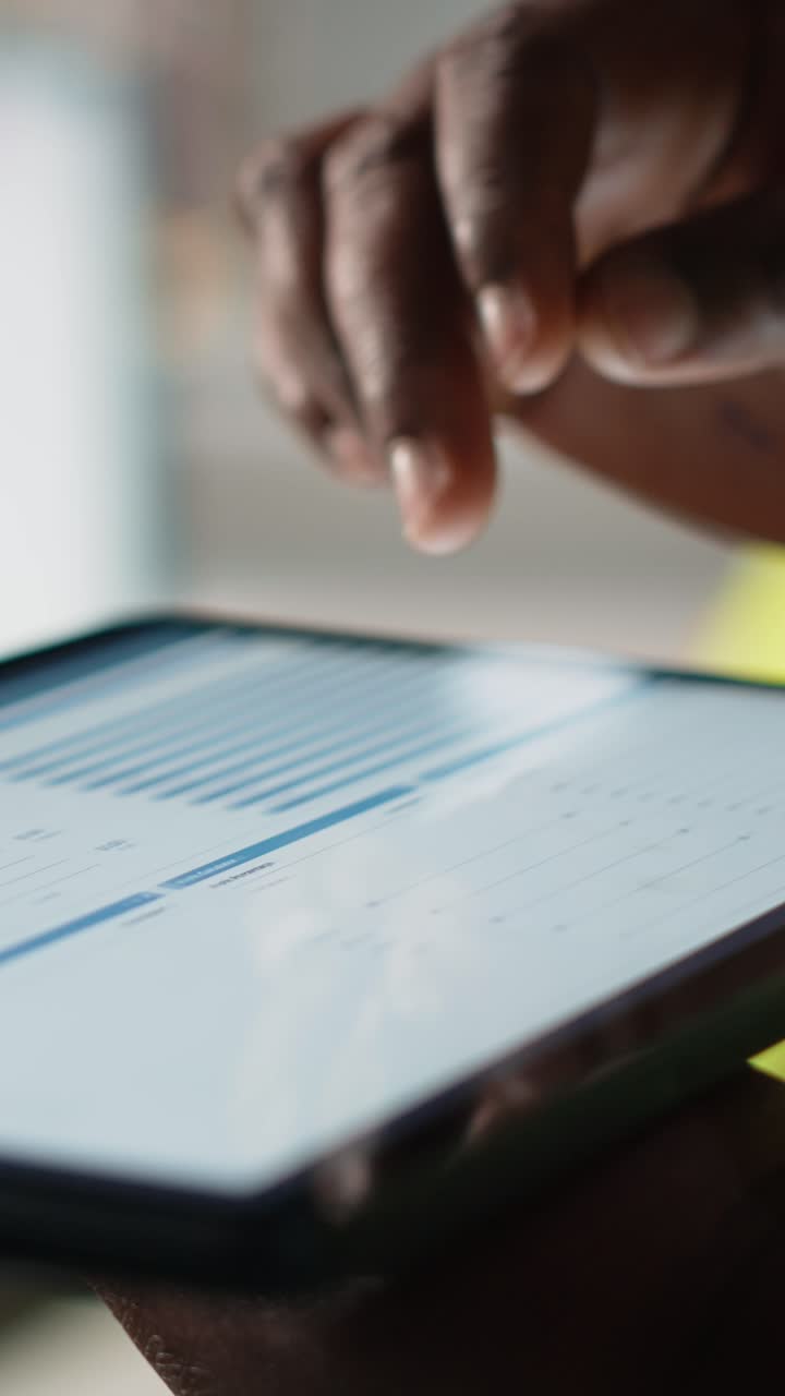 Vertical Video Close up of black woman monitoring e-commerce activity on tablet