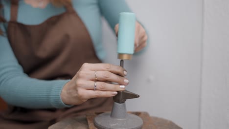 woman jewelry maker working on a piece