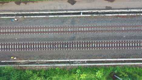 overhead view of train tracks with people