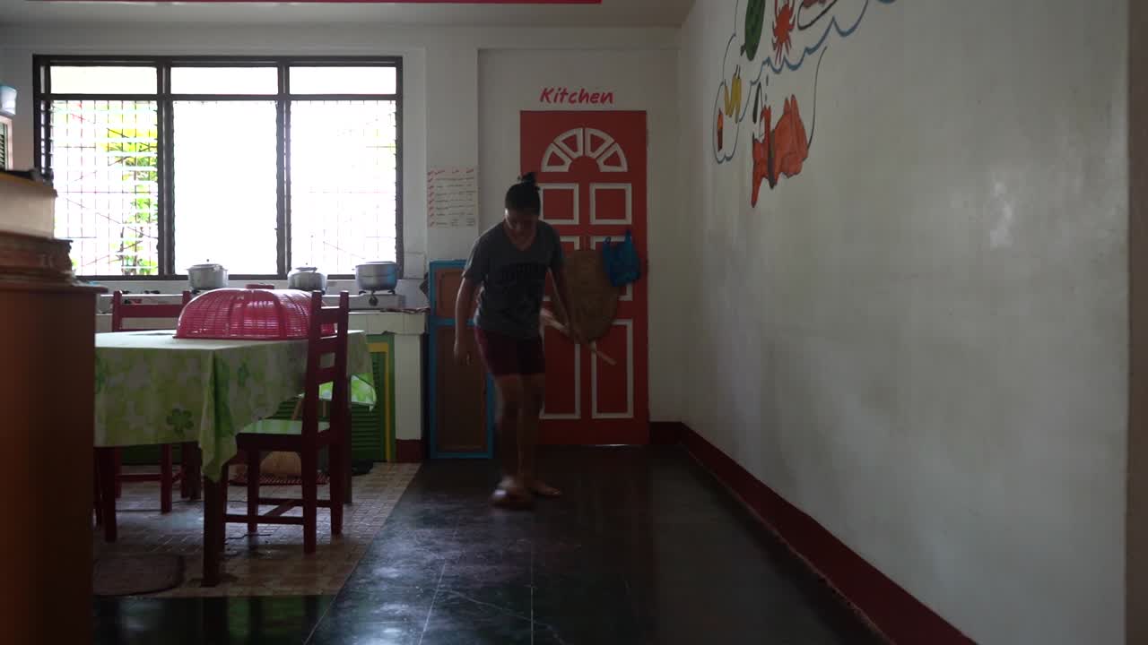 Filipina Orphan Girl Doing Household Chores And Scrubbing The Floor At The Orphanage Home In The Philippines - static shot