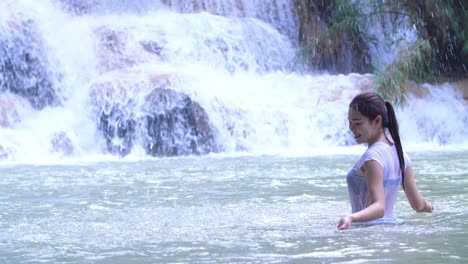woman having fun at a waterfall