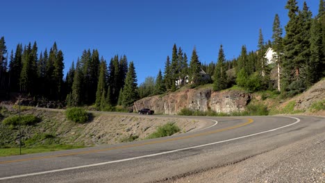 cars driving on the million dollar highway in the san juan mountains
