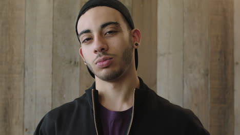 close up portrait of confident young hispanic man student wearing cool trendy fashion looking serious at camera