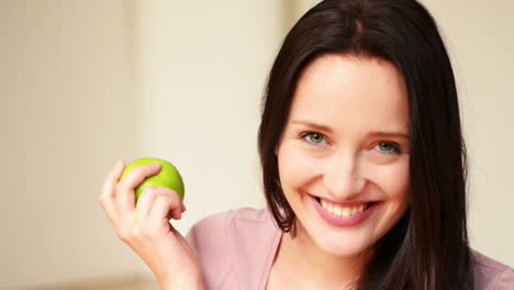 pretty girl eats green apple