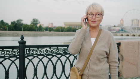 senior woman talking on phone outdoors