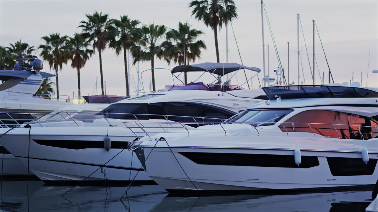 Antibes, France - May 8, 2025: Multiple white boats docked in the Port Vauban at sunset