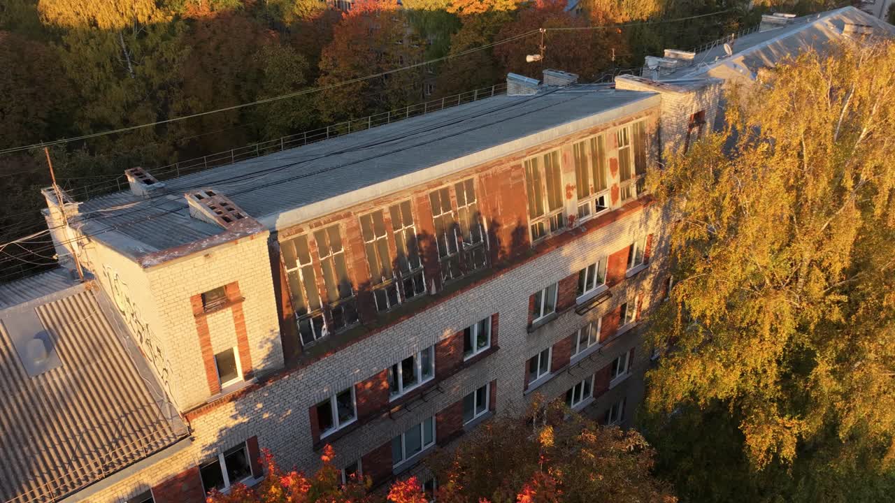 Early sunlight on Khrushchyovka-style building in Riga with large attic windows