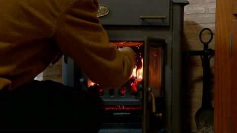 person tending a wood stove
