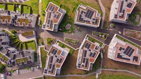 aerial top down of modern houses and apartments with solar panels on roof. green garden on rooftop of luxury homes in swiss city. beautiful summer day with green garden. wil, switzerland.