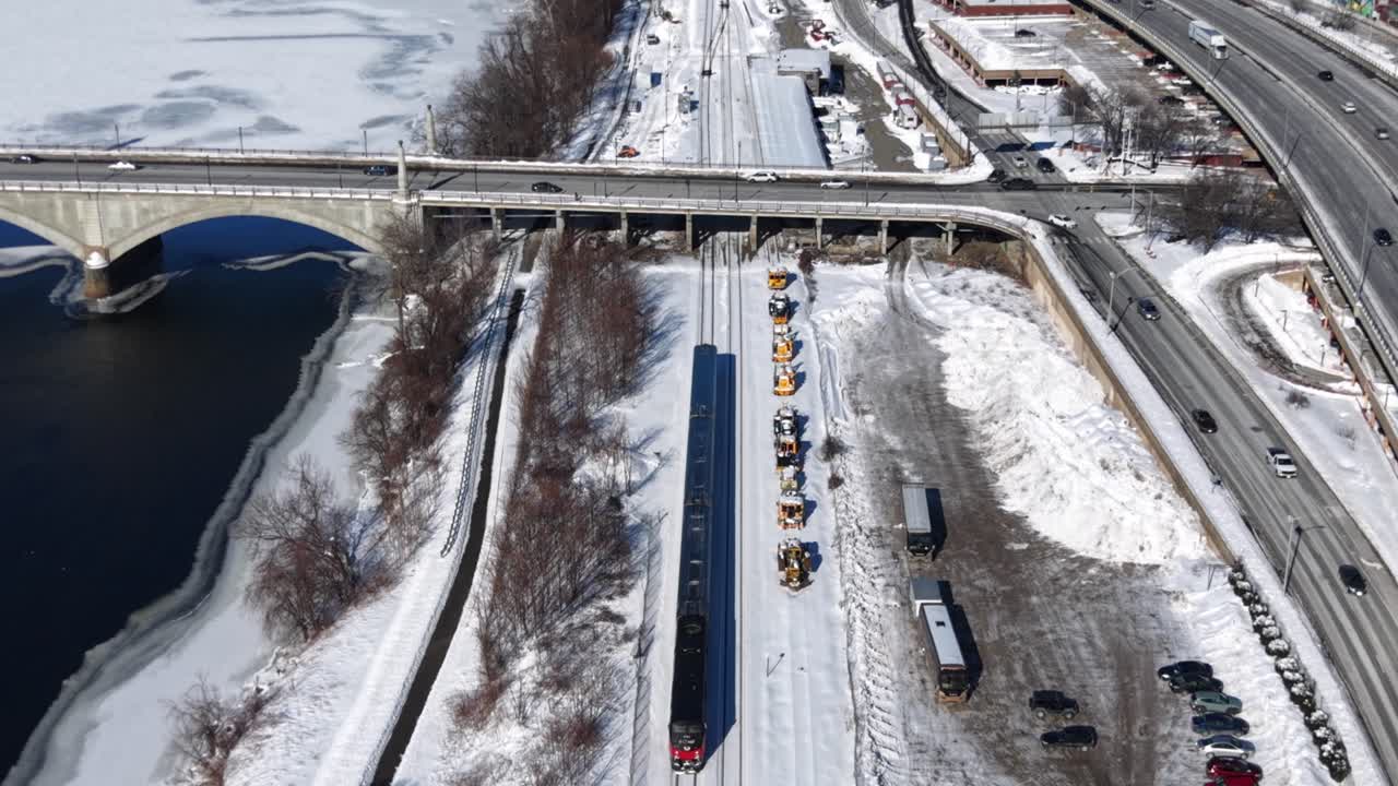 Snowy aerial view of train by river in Springfield, Massachusetts