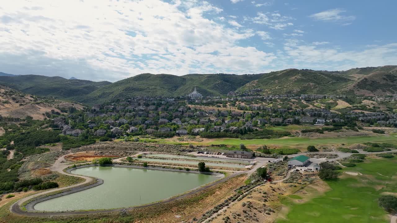 Aerial View of a Town Surrounded by Mountains and a Golf Course