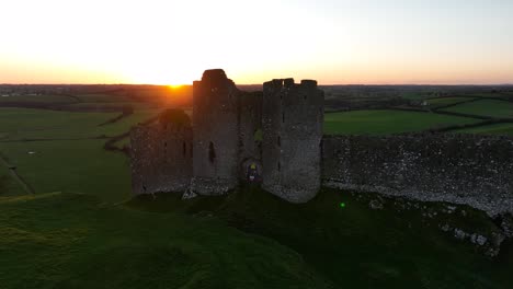 ancient castle ruins at sunset in a green landscape