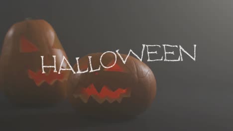 Animation-of-halloween-text-over-carved-pumpkins-on-grey-background